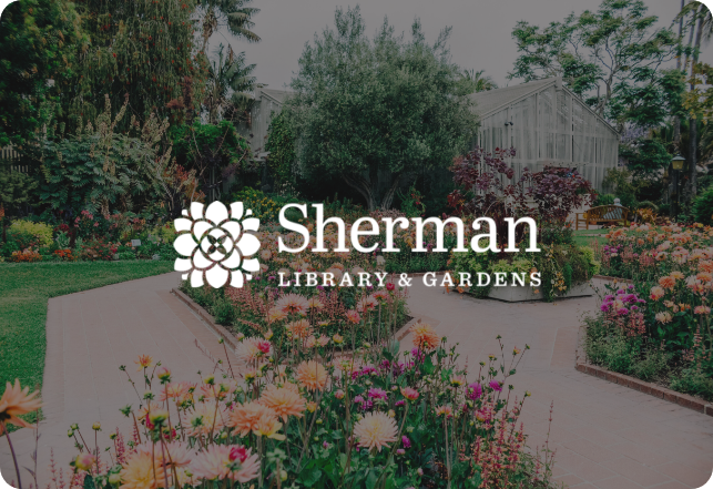 A garden scene with vibrant flowers and lush greenery surrounds a clear pathway. A greenhouse is visible in the background. The text "Sherman Library & Gardens" with a floral logo overlays the image in white.